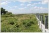 Land by Mekong with wall fence about 18km from city center